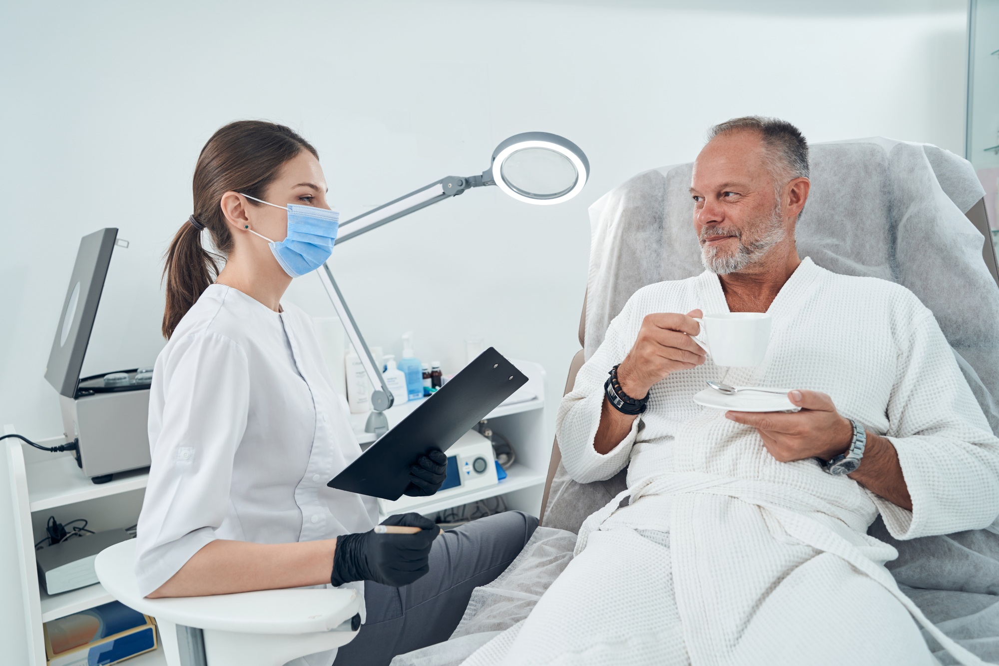 Man having consultation with doctor in cosmetology clinic